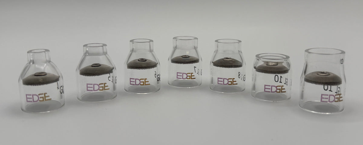 Row of clear glass EDGE welding cups with mesh diffusers on white background